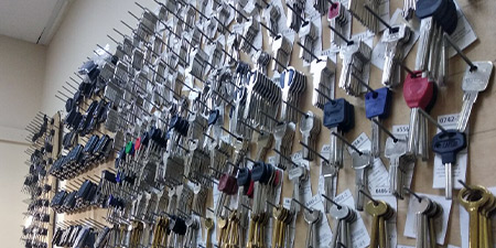 Many blank keys hanging on a wall