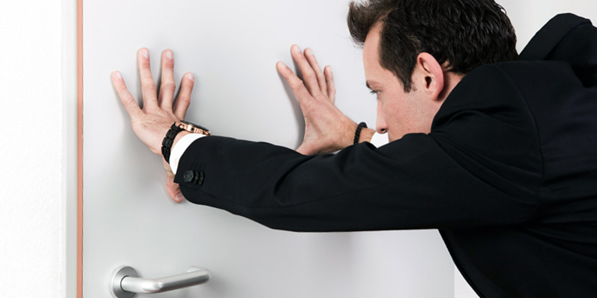 A lockout man pushing door