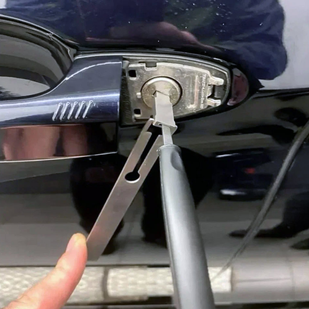 Car lockout service technician using professional tools to unlock a vehicle door in Panama City Beach