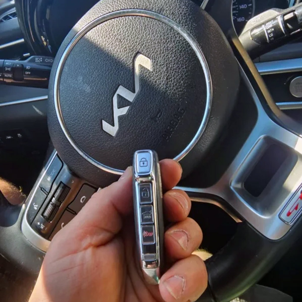 Kia smart key programming by automotive locksmith in Panama City Beach — new key fob synced to vehicle on-site.