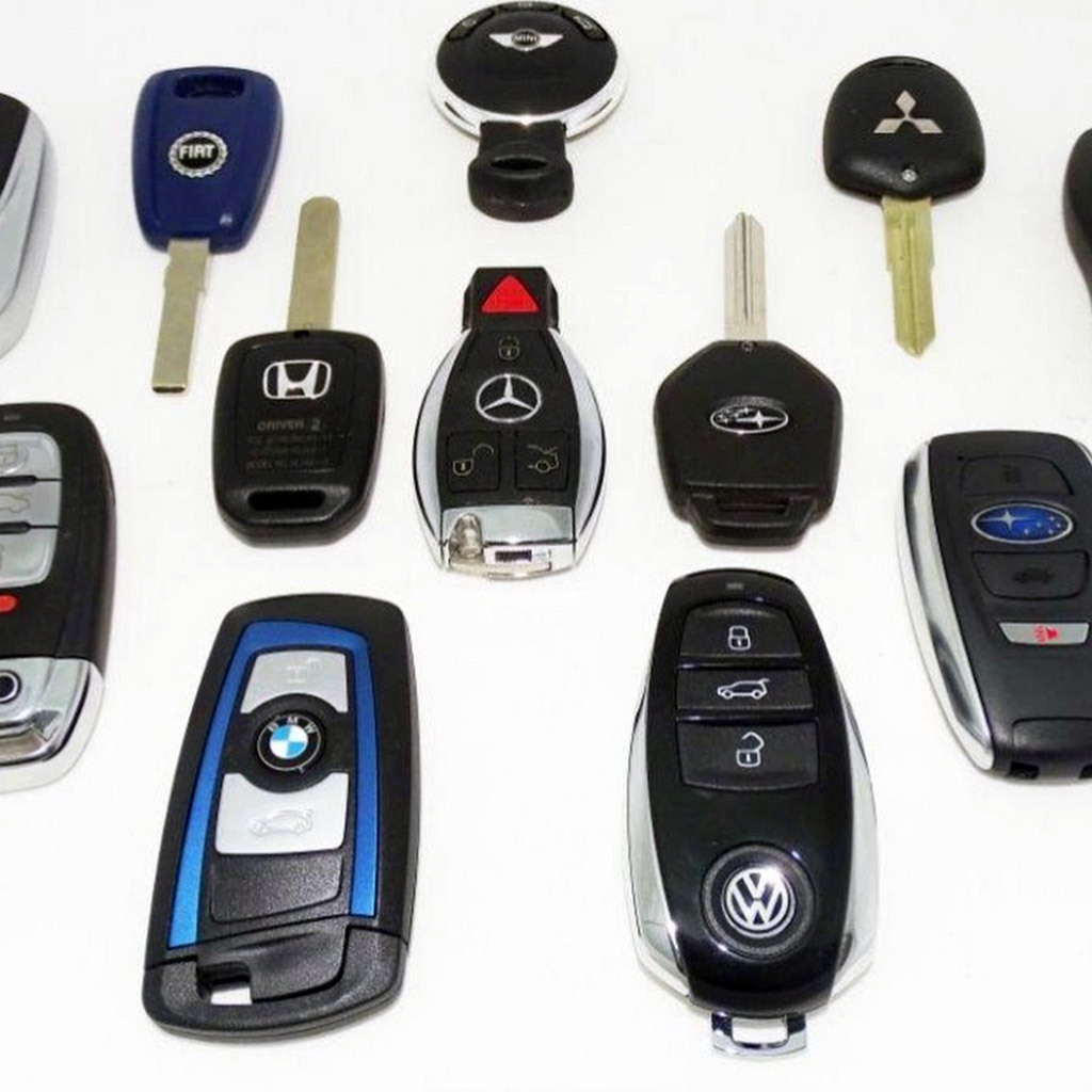 Assortment of OEM car keys for multiple vehicle brands displayed on a white background in Panama City Beach.