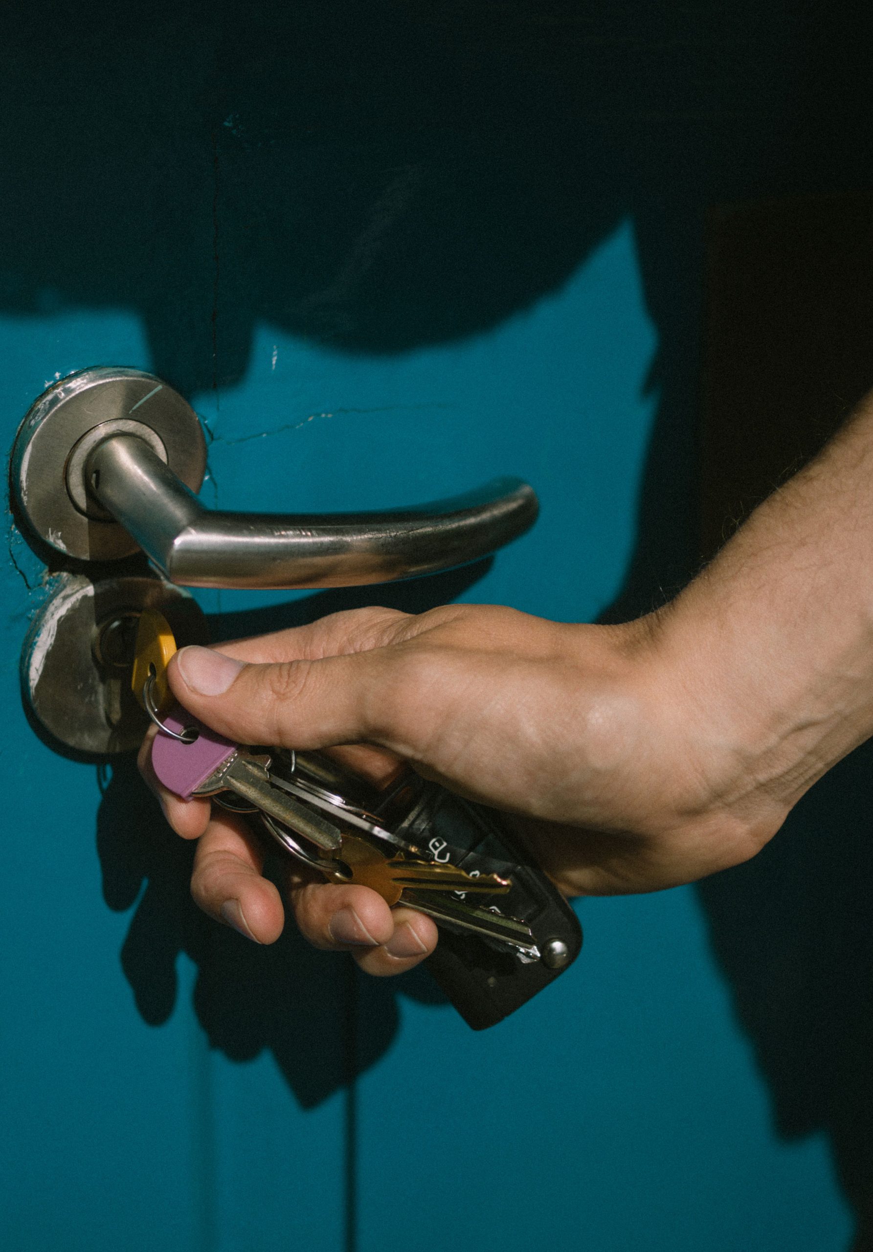 Hand unlocking an exterior door during an emergency lock situation